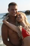 Romantic Couple Standing At Beach Stock Photo