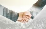 Double Exposure Handshake Of Business Peoples Stock Photo