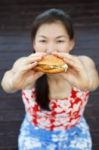 Woman Eating A Hamburger Stock Photo