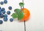 Tangerine And Blueberry On White Table Stock Photo