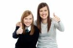 Charming Daughter With Her Mother Showing Thumbs Up Sign Stock Photo