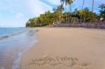 Inscription Of Vacation Written On Wet Yellow Beach Sand With Fo Stock Photo