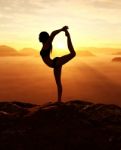 3d Rendering Of Woman Doing Yoga And Meditates On The Mountain Stock Photo