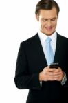 Smiling Businessperson Messaging Stock Photo