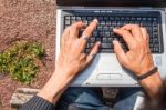 Human Hands Typing A Laptop Stock Photo