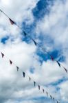 Triangle Flag Hanging On The Rope And Blue Sky Stock Photo