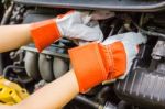 Car Mechanic In His Repair Shop Standing Next To The Car - Close Stock Photo