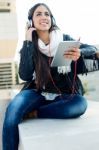 Beautiful Girl Listening To Music In City Stock Photo