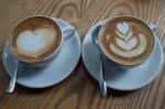 A Cup Of Coffee With Heart Pattern In A White Cup Stock Photo