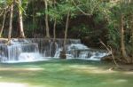 The Water Flowing Over Rocks And Trees Down A Waterfall At Huay Mae Khamin Waterfall National Park ,kanchana Buri In Thailand Stock Photo