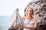 Beautiful Young Blonde Woman Posing Outdoor At The Rocky Sea Sho Stock Photo