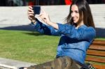 Beautiful Young Woman Using Her Mobile Phone In The Street Stock Photo