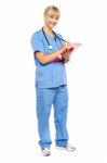 Smiling Nurse Preparing Case Sheet Of A Patient Stock Photo