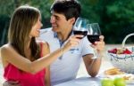 Attractive Couple Drinking Wine On Romantic Picnic In Countrysid Stock Photo