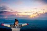 Woman Tourist Watching The Sunrise Stock Photo