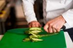 Chef Chopping Leek Over Green Carving Board Stock Photo