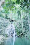 Small Waterfall Flowing Into A Calm Pool Of Water Stock Photo