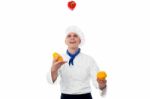 Chef Juggling With Vegetables Stock Photo