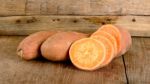 Sweet Potato On The Wooden Background Stock Photo