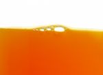 Yellow Bubbles In The Orange Juice Stock Photo