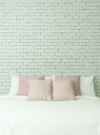 The Bed On White Bricks Wall Background Vertical Stock Photo