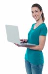 Woman With A Bright Smile, Using Laptop Stock Photo