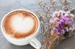 Coffee Cup With Beautiful Violet Flower Stock Photo