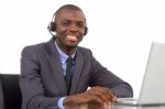 Businessman With Headset And Laptop Stock Photo