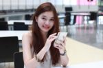 Portrait Of Thai Adult Beautiful Girl Using Her Smart Phone And Smile Stock Photo