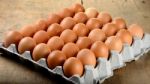 Egg In Packet On Wooden Background Stock Photo