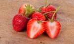 The Strawberry On Wood Background Stock Photo