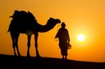 A Desert Local Walks A Camel Through Thar Desert Stock Photo