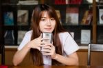 Portrait Of Thai Adult Student University Uniform Beautiful Girl Using Her Smart Phone Stock Photo