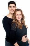 Guy With Arms Around Her Girlfriend's Waist Stock Photo