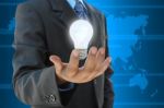 Businessman Hand Holding Light Bulb Stock Photo