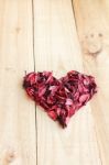 Heart Formed By Red Rose Petals On Wooden Background Stock Photo