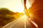 Red Old Bus Going Fast On The Highway Stock Photo