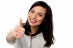 Smiling Young Woman Showing Thumbs Up Stock Photo