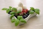 Appetizer Of Mozzarella, Cherry Tomatoes And Olives And Basil Stock Photo