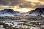 Snowy Icelandic Mountains With Dramatic Cloudy Sky Stock Photo