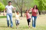 Family Walking In The Park Stock Photo