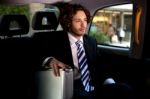 Handsome Businessman Inside Taxi Cab Stock Photo