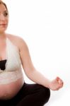 Pregnant Female Doing Yoga Stock Photo