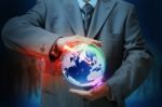 Businessman Holding Glowing Global Stock Photo