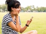 A Young Girl With Headphones Outdoors. Listening Music Stock Photo