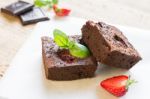 Chocolate Brownie Cake Decorated With Strawberries. Selective Fo Stock Photo