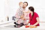 Family Preparing Food In The Kitchen Stock Photo