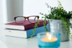 Books, Glasses And Candle On The Night Table Stock Photo