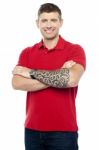 Guy Standing With Folded Arms Stock Photo