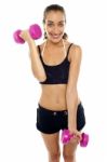 Smiling Fit Woman Working Out With Dumbbells Stock Photo